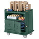 A green Cambro beverage service cart with 2 doors full of food and drinks.
