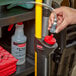 A person using a Rubbermaid Pulse Liquid Caddy to dispense cleaning solution.