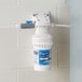 A white plastic C Pure Oceanloch-S water filter with a blue label attached to a wall.