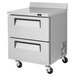 A stainless steel Turbo Air worktop refrigerator with two drawers on wheels.