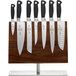 Mercer Culinary Genesis 8-piece knife set on a wooden board.