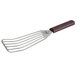 A Mercer Culinary left-handed slotted fish/egg turner with a brown Hell's Handle.