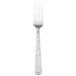 A silver Walco Vestige dinner fork with a white background.