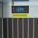 A digital display on a metal surface above a Delfield refrigerated cold food well.