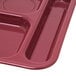 A dark cranberry Carlisle melamine tray with six compartments.