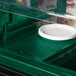 A green Cambro Versa Well cover on a white plate.