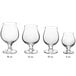 A row of clear stemmed Acopa Belgian beer tasting glasses.