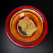 A multi-color Elite Global Solutions melamine bowl filled with chips on a black surface.