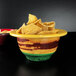 A close-up of a multi-color melamine bowl of chips on a table.