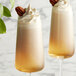 Two glasses of DaVinci Gourmet Classic Praline flavoring syrup drinks with a pecan on top.