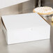 A white bakery box on a table.