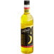 A close up of a bottle of DaVinci Gourmet Classic Banana Flavoring syrup with a banana on it.