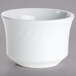 A Tuxton bright white china bouillon cup with an embossed rim on a gray surface.