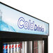 A Turbo Air black refrigerated merchandiser filled with soda cans.