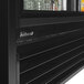 A black Turbo Air refrigerated merchandiser with two glass sliding doors.