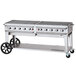 A large stainless steel Crown Verity outdoor grill on wheels.
