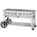 A large stainless steel Crown Verity outdoor grill on a cart.