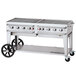 A large stainless steel Crown Verity outdoor grill with a cart.