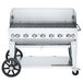 A Crown Verity stainless steel mobile outdoor grill with wheels and a lid.