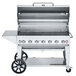 A Crown Verity stainless steel mobile grill with wheels and a lid.