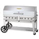 A large silver stainless steel Crown Verity outdoor grill with wheels and a roll dome.