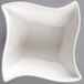 A white Squavy porcelain ramekin with a wavy edge.