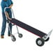 A man using a Magliner convertible hand truck with pneumatic wheels and a U-loop handle.