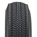A close up of a pneumatic tire on a white background.