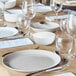 A table set with Arcoroc granite gray glass plates and glasses.