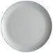 An Arcoroc granite gray opal glass coupe plate with a small white rim.