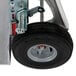 A close up of a Magliner hand truck wheel with a black tire.