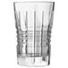 A clear glass highball with a patterned design.