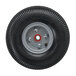 A black Magliner hand truck wheel with a silver rim and white tire.