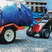 A blue tarp on a trailer attached to a Magliner motorized hand truck.