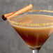 A brown DaVinci Gourmet Sugar Free Pumpkin Pie flavored cocktail with a cinnamon stick garnish.