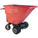 A red Magliner motorized self dumping hopper cart with wheels and dual handle bars.