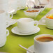 A table set with white Arcoroc saucers and cups.