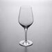 A Stolzle Exquisit Royal Bordeaux wine glass on a gray surface.