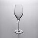 A clear Stolzle Exquisit flute wine glass on a gray surface.