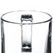 A close up of a clear glass Libbey warm beverage mug with a handle.