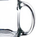 A Libbey clear glass warm beverage mug with a handle.