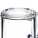 A close up of a Libbey clear glass warm beverage mug with a handle.