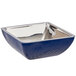 A Bon Chef cobalt blue square bowl with silver accents on a counter in a salad bar.