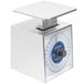 An Edlund stainless steel mechanical portion scale with a blue dial on a counter.