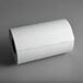 A roll of Choice white butcher paper on a gray surface.