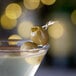 A martini with Belosa Jalapeno & Garlic Stuffed Queen Olives on it.