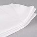 A stack of white Hoffmaster Quickset linen-like dinner napkins.