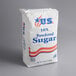 A white bag of 10X confectioners sugar with red and blue text.