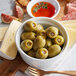A bowl of Belosa onion stuffed green olives and cheese on a table in an Italian restaurant.