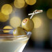 A martini with Belosa hickory-smoked almond stuffed olives on a stick.